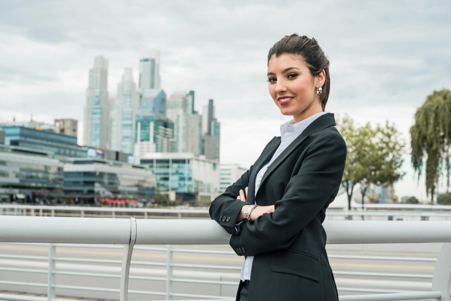 portrait-smiling-businesswoman-standing-front-cityscape